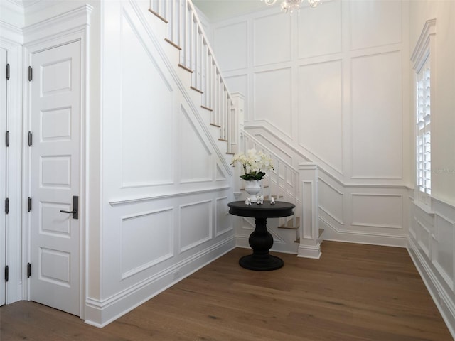 staircase with hardwood / wood-style flooring