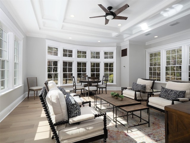 living room with crown molding and plenty of natural light