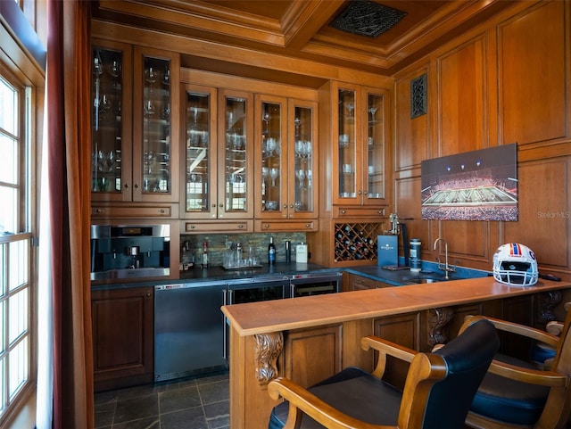 bar featuring beamed ceiling, sink, ornamental molding, coffered ceiling, and stainless steel oven