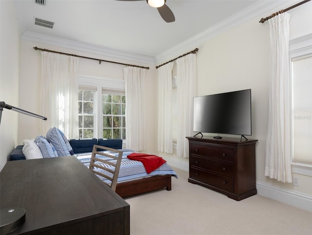 bedroom with crown molding, light colored carpet, and ceiling fan