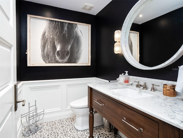 bathroom with vanity, tile patterned floors, and toilet