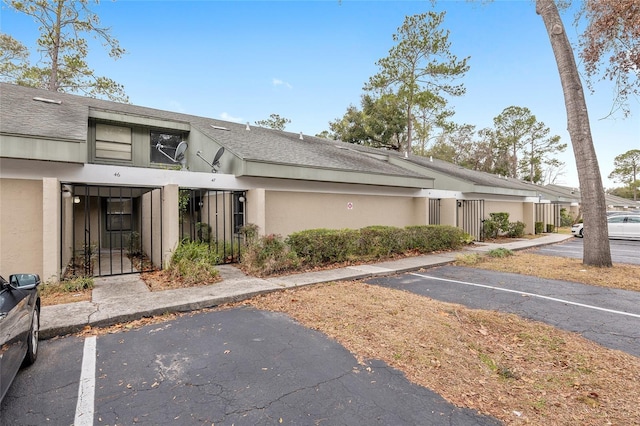 view of property featuring a fenced front yard and uncovered parking