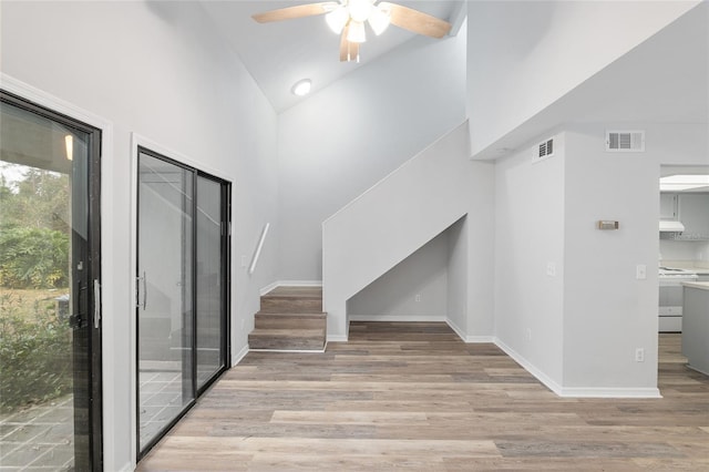 interior space featuring stairway, wood finished floors, visible vents, and baseboards