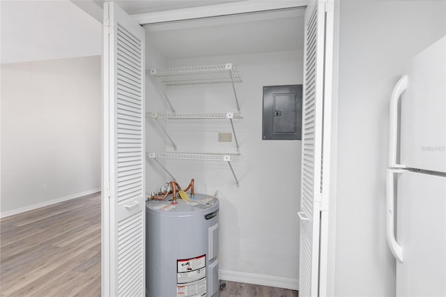 utility room featuring electric panel and water heater