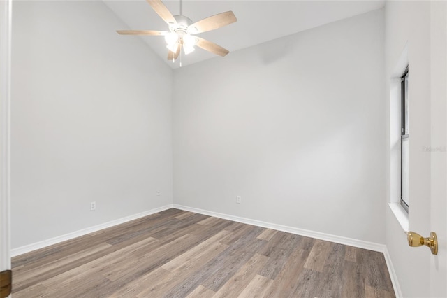 spare room featuring ceiling fan, wood finished floors, and baseboards