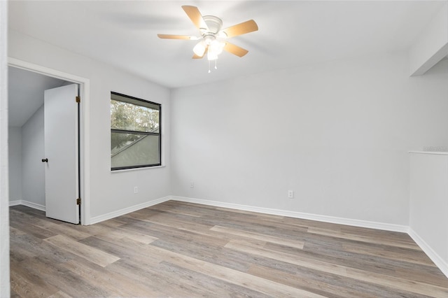 empty room featuring a ceiling fan, baseboards, and wood finished floors