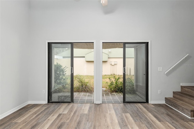 doorway featuring stairway, plenty of natural light, and wood finished floors