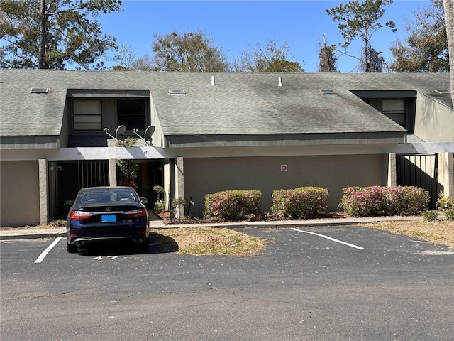 view of building exterior featuring uncovered parking