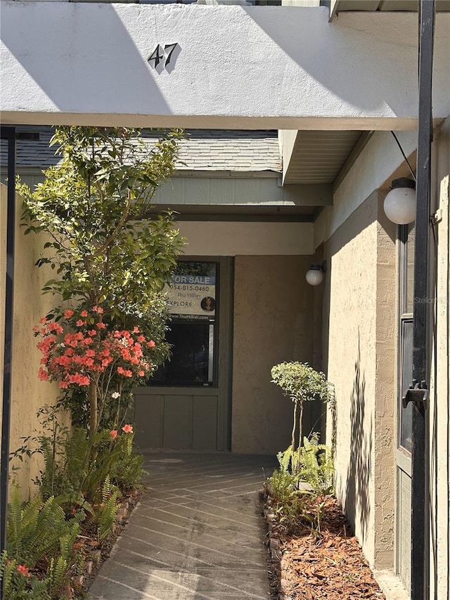 property entrance with stucco siding