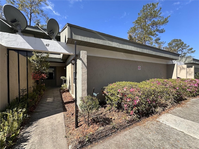 view of side of home featuring stucco siding