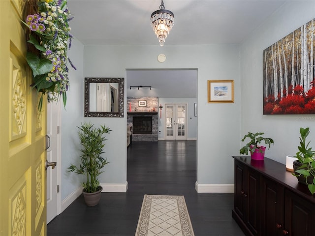 corridor featuring an inviting chandelier and dark hardwood / wood-style flooring