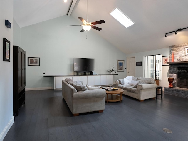 living room featuring dark wood-type flooring, high vaulted ceiling, beamed ceiling, ceiling fan, and a fireplace