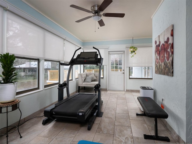 exercise area with ceiling fan and light tile patterned floors