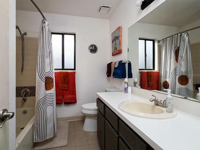 full bathroom with shower / tub combo with curtain, tile patterned floors, toilet, and vanity