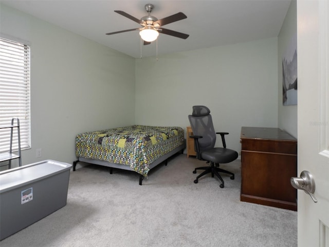 bedroom featuring multiple windows, light carpet, and ceiling fan