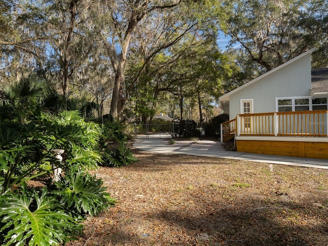 view of yard with a wooden deck and a patio