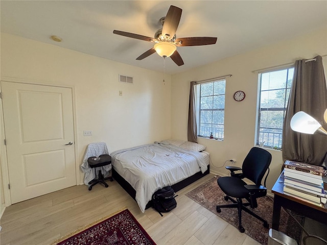 bedroom with ceiling fan and light hardwood / wood-style flooring