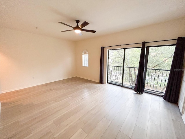 empty room with ceiling fan and light wood-type flooring