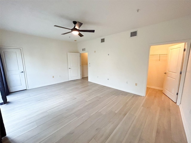 unfurnished room with ceiling fan and light hardwood / wood-style floors