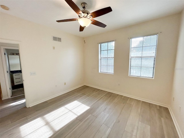 empty room featuring ceiling fan and light hardwood / wood-style floors