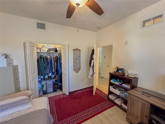 bedroom with light hardwood / wood-style flooring, a closet, and ceiling fan