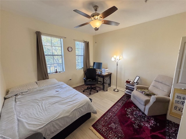 bedroom with wood-type flooring and ceiling fan