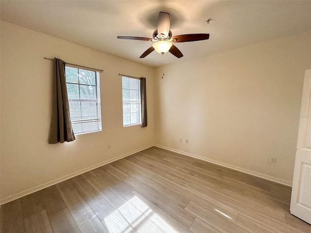 spare room featuring ceiling fan and light wood-type flooring