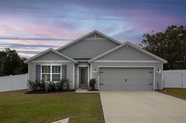 view of front of property with a lawn and a garage