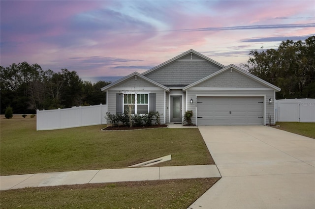 view of front of home featuring a garage and a yard