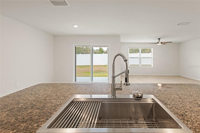 kitchen featuring ceiling fan and sink