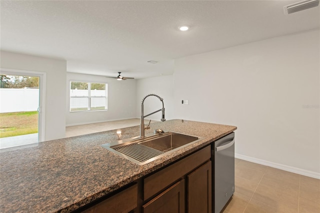 kitchen featuring ceiling fan, dishwasher, sink, light tile patterned floors, and dark brown cabinets