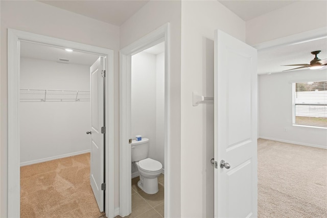 bathroom featuring ceiling fan and toilet