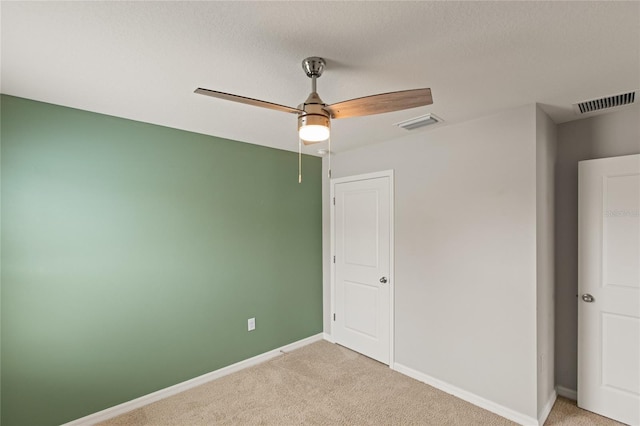 unfurnished bedroom featuring ceiling fan and light carpet