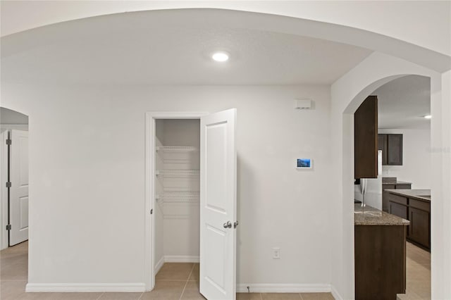 bedroom featuring a closet and light tile patterned floors