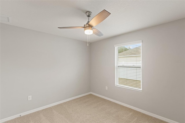 carpeted empty room featuring ceiling fan