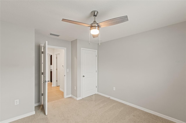 unfurnished bedroom with ceiling fan and light carpet