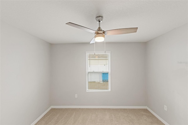 spare room with carpet, ceiling fan, and a textured ceiling