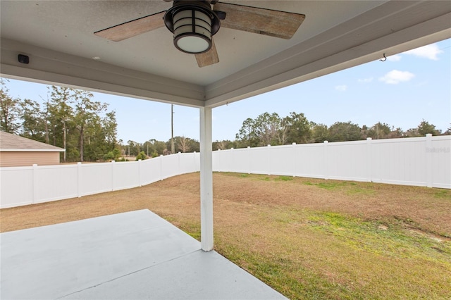 view of yard featuring ceiling fan and a patio