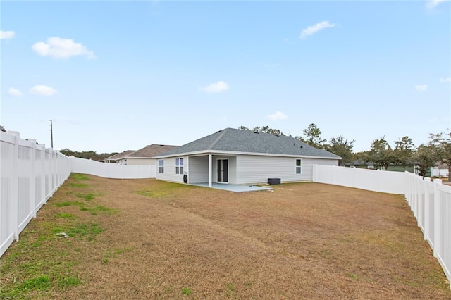 back of house featuring a yard and a patio