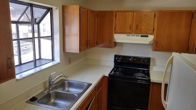 kitchen with black / electric stove, white refrigerator, and sink