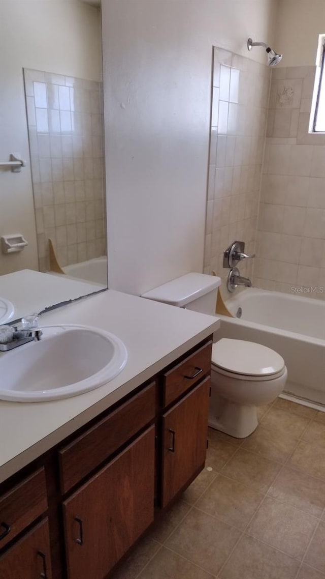 full bathroom with tiled shower / bath combo, vanity, tile patterned flooring, and toilet