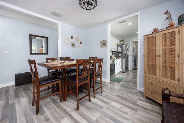 dining area with light hardwood / wood-style flooring