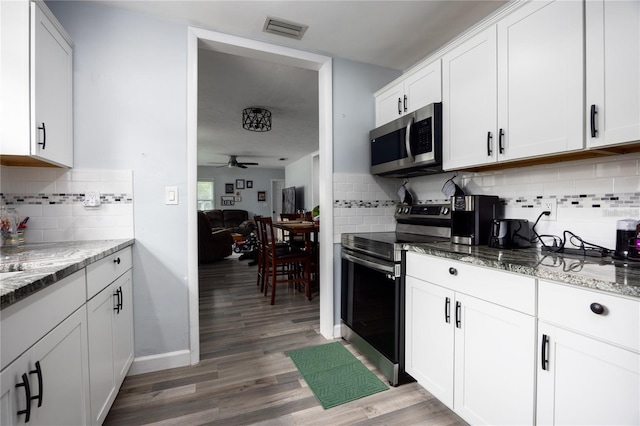 kitchen featuring ceiling fan, light stone counters, white cabinetry, and stainless steel appliances