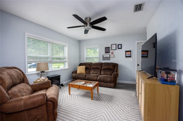 living room featuring ceiling fan and light hardwood / wood-style floors