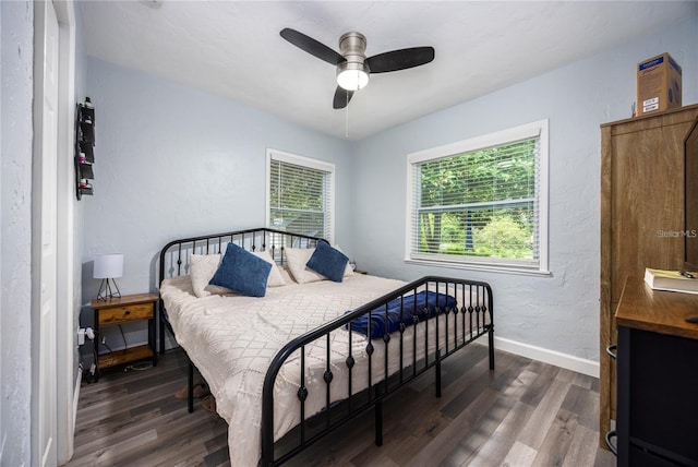 bedroom with ceiling fan and dark hardwood / wood-style flooring