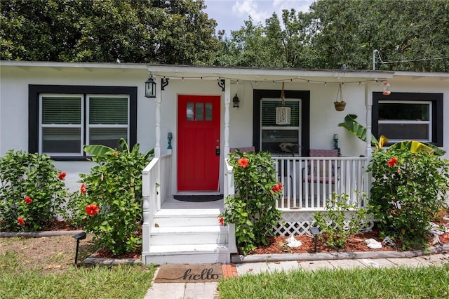 property entrance featuring covered porch