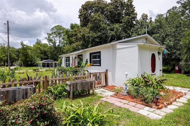 back of house featuring a yard