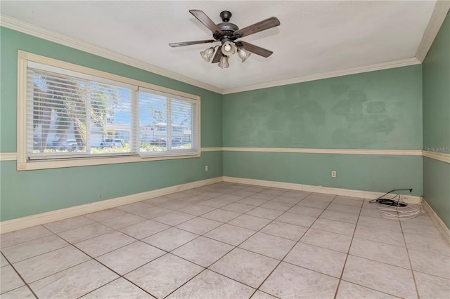 tiled spare room featuring ornamental molding and ceiling fan