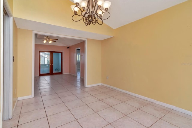 tiled spare room featuring french doors, ceiling fan with notable chandelier, and vaulted ceiling