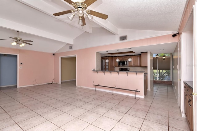 unfurnished living room with light tile patterned flooring, vaulted ceiling with beams, ceiling fan, and a textured ceiling